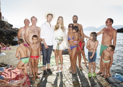 Bridal couple and guests on the beach
